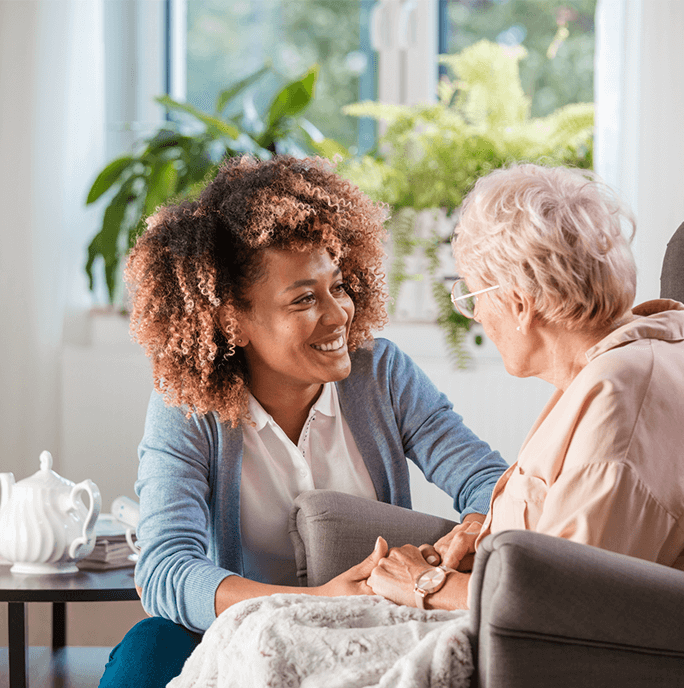 Nurse speaking to senior woman