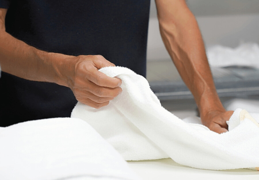 Employee doing caregiving services like laundry