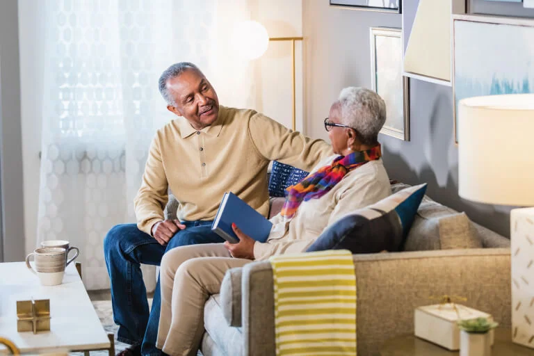 two seniors talking on couch