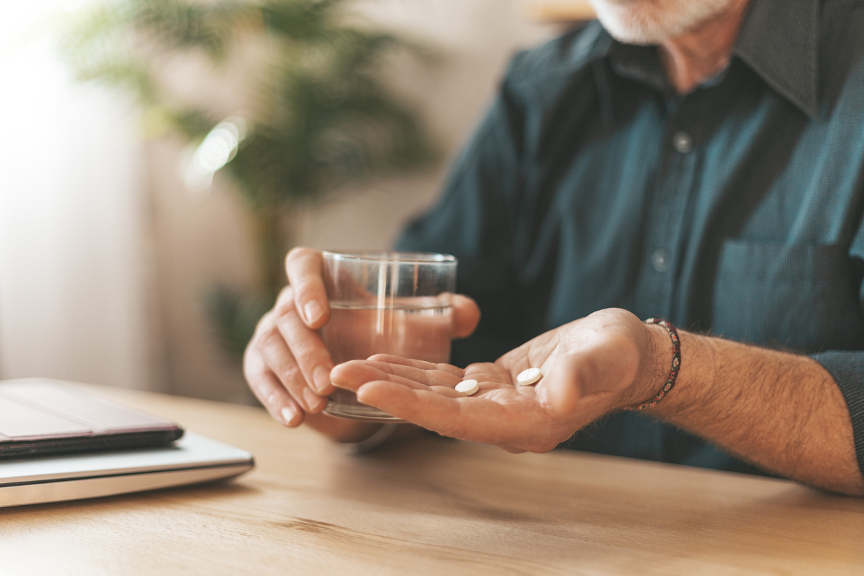 Senior man taking vitamins