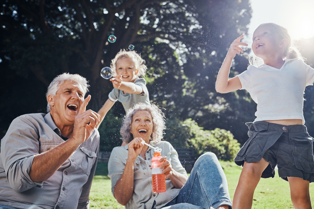 Grandparents with grandkids blowing bubbles